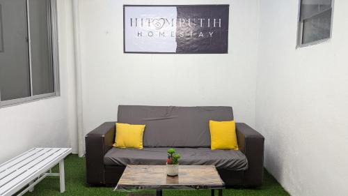 a living room with a couch and a table at Homestay Kemaman - Hitam Putih Homestay in Cukai