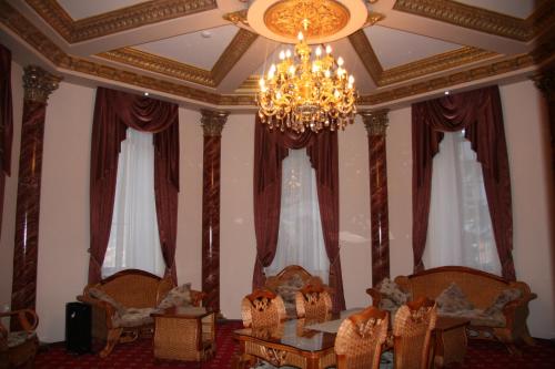 a room with a chandelier and chairs and a table at Borjomi Palace Health & Spa Center in Borjomi