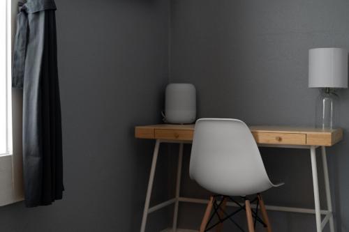 a white chair sitting in front of a desk at Summerset Cottage Atlanta in Atlanta