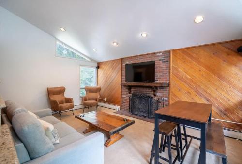 a living room with a couch and a fireplace at Local's Condo in Vail Steps from Ski Shuttle in Vail