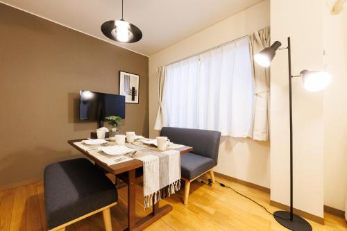 a dining room with a table and two chairs at アンファング森ノ宮 in Osaka