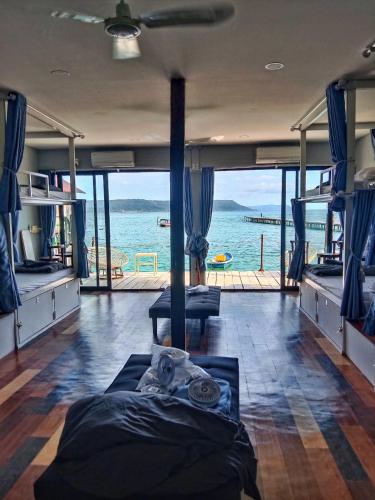 a room with a bed and a view of the ocean at Ankounamatata in Koh Rong Island