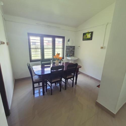 a dining room with a table and chairs at Serenity in Trivandrum