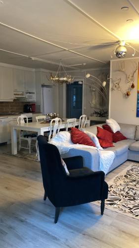 a bedroom with two beds and a dining room at Villa Shaman in Rovaniemi