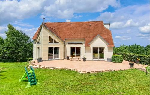 a house with a large patio in the yard at 3 Bedroom Amazing Home In Carrouges in Carrouges