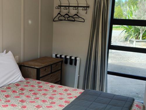 a bedroom with a bed and a window at Braxmere Lodge in Turangi
