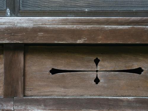 a wooden door with a black arrow on it at RITA Izumo Sagiura in Izumo