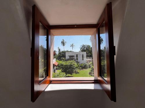 a window in a room with a view of a house at Villas Cononda in La Majahua