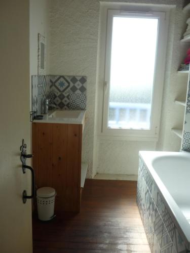 a bathroom with a sink and a window at La landaise in Laluque