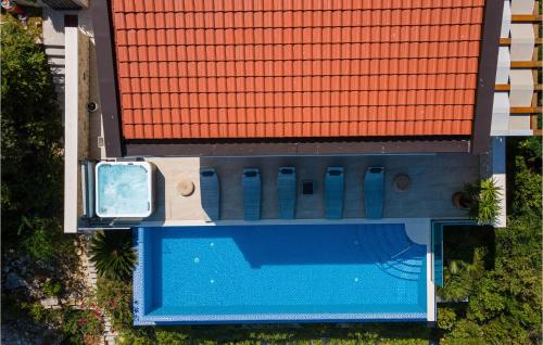an overhead view of a swimming pool with a red roof at Pet Friendly Home In Prigradica in Prigradica