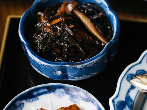 two blue and white bowls of food on a table at RITA Izumo Sagiura in Izumo