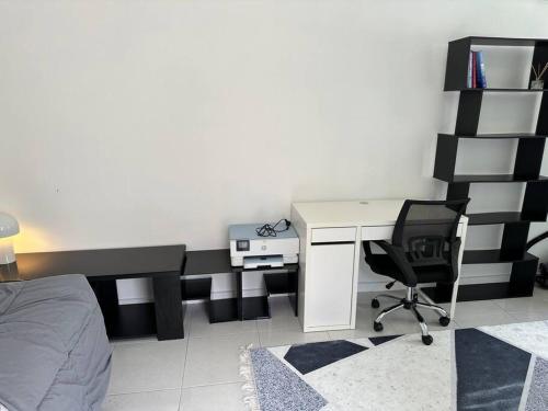 a bedroom with a desk and a bed and a desk and chair at Quiet, private studio 1 double bed and extra matress in Mount Pritchard