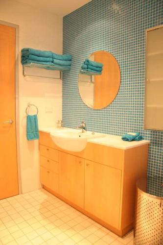 a bathroom with a sink and a mirror at Starfish Beach House - WIFI - 5 min walk to beach in Hyams Beach