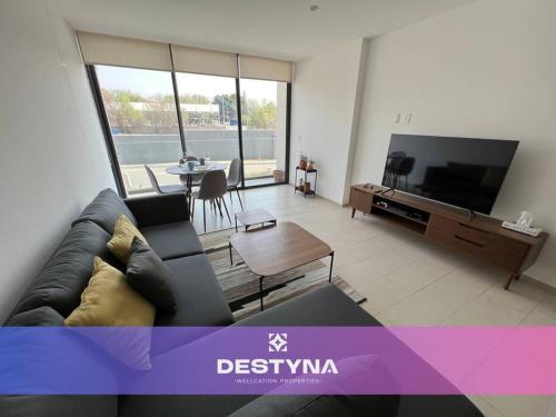 a living room with a couch and a tv at Latitud Puerta La Victoria 10 min from center in Querétaro