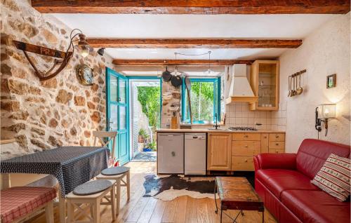a living room with a red couch and a kitchen at Villa La Maison Adriatique in Zadar
