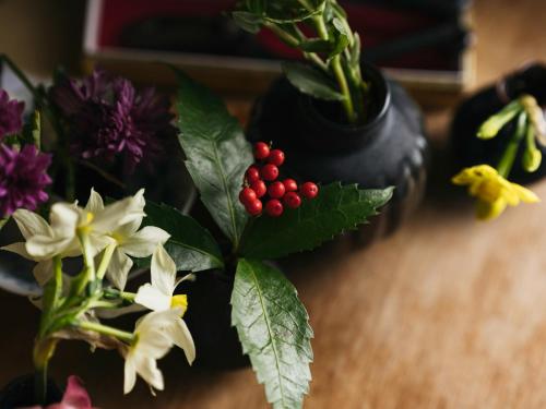 a vase filled with flowers and plants on a table at RITA Izumo Sagiura in Izumo