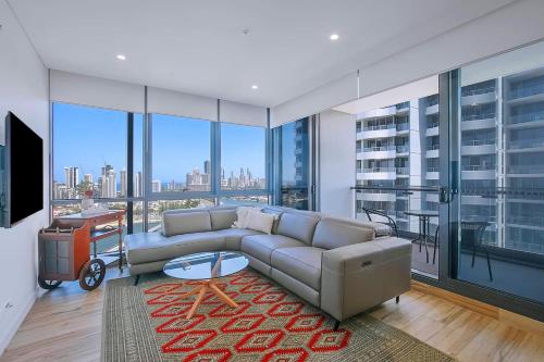 a living room with a couch and a large window at Sundale at Southport - Resort-style Panorama in Gold Coast