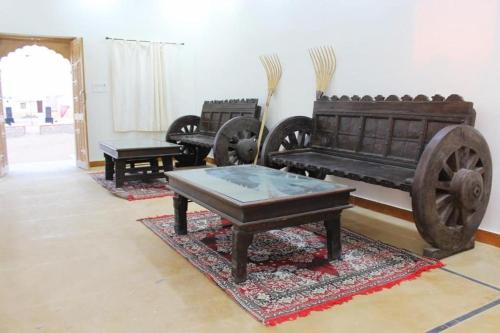a living room with antique furniture in a room at Golden Heaven Desert Camp in Jaisalmer