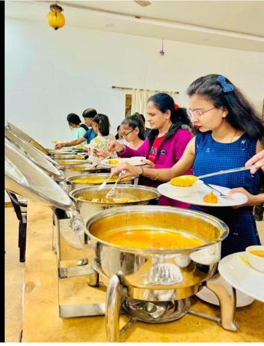 a group of women preparing food in a kitchen at Golden Heaven Desert Camp in Jaisalmer