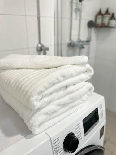 a pile of white towels sitting on top of a toaster at StyleStudio Areena1 in Tampere