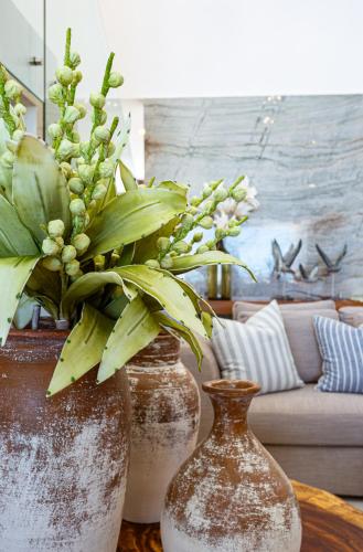 two vases sitting on a table with flowers in them at New Luxury Beachfront house! in San Benito