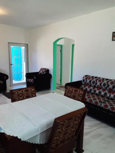 a living room with a table and two chairs at Sea Beach Escape & Vacation Rental in Negril