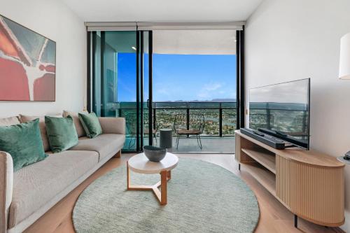 a living room with a couch and a table at Serain Residences Next to Casino Gold Coast in Gold Coast