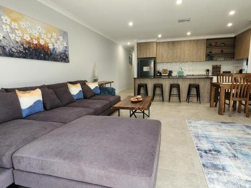a living room with a couch and a kitchen at Minutes to the Beach! King Bed with TV, Spa Bath in Christies Beach