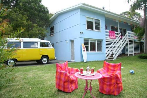 a house with a table and two chairs in the yard at Laguna Blue Beach House-WIFI-Beach Access in Hyams Beach