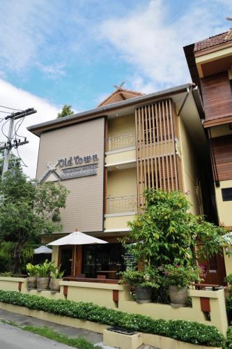 a building with a sign that reads wild too pass up at Old Town Chiangmai Boutique in Chiang Mai