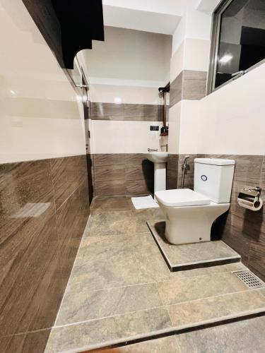 a bathroom with a toilet and a shower at Ocean Front Villa in Hikkaduwa