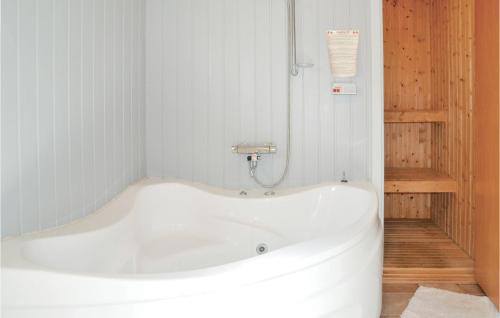 a white bath tub in a bathroom with white walls at Holiday Home Skovbrynet X in Lindet