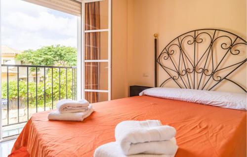 a bedroom with two towels on a bed with a window at 2 Bedroom Gorgeous Apartment In Málaga in Málaga