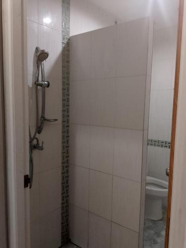 a bathroom with a shower and a toilet at Lucky Guest house in Karon Beach