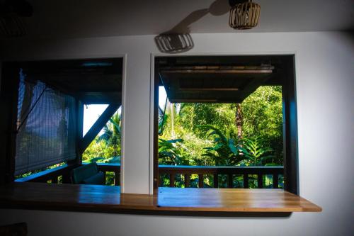 a window in a room with a view of a garden at OHANA Jungle Lodges in Les Avirons