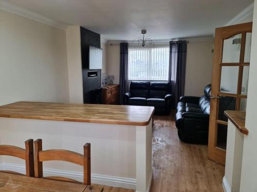 a living room with a bar and a couch at Modern 3 Bedroom Property centrally based in Balivanich