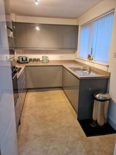 a kitchen with a sink and a counter top at Modern 3 Bedroom Property centrally based in Balivanich
