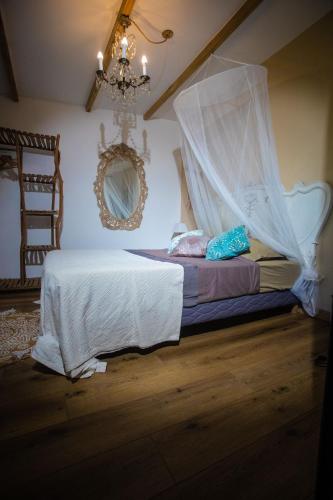 a bedroom with a bed with a mosquito net at OHANA Jungle Lodges in Les Avirons