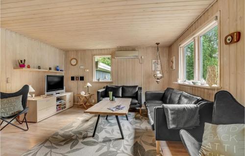 a living room with leather furniture and a tv at Three-Bedroom Holiday Home In Thyholm in Thyholm