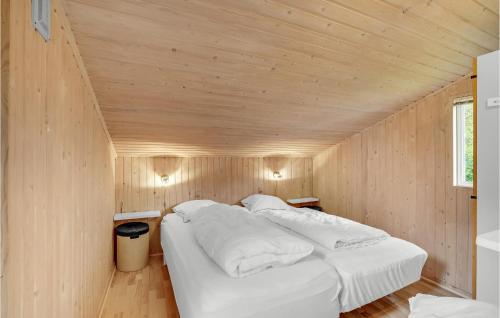 a bedroom with two beds in a wooden room at Three-Bedroom Holiday Home In Thyholm in Thyholm