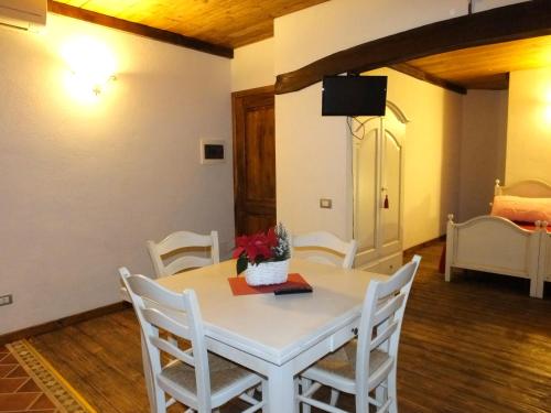 a dining room with a white table and chairs at Agriturismo Adriano Pedretti in Badia Polesine