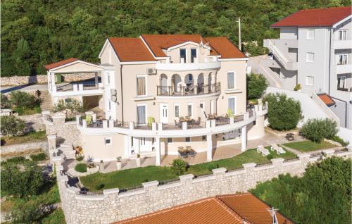 an aerial view of a large white house at Two-Bedroom Apartment In Komarna in Klek
