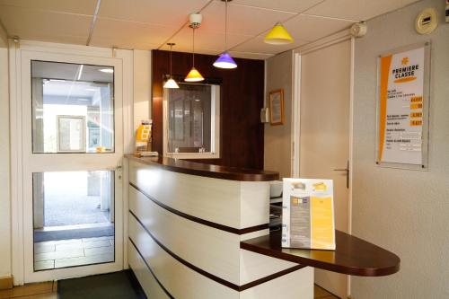 a kitchen with a counter with a box on it at Premiere Classe Tours Sud - Chambray Lès Tours in Chambray-lès-Tours