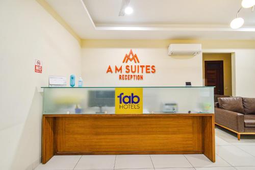 a large aquarium in a room with a couch at FabHotel Prime AM Suites - Nr Yashoda Hospitals in Hyderabad