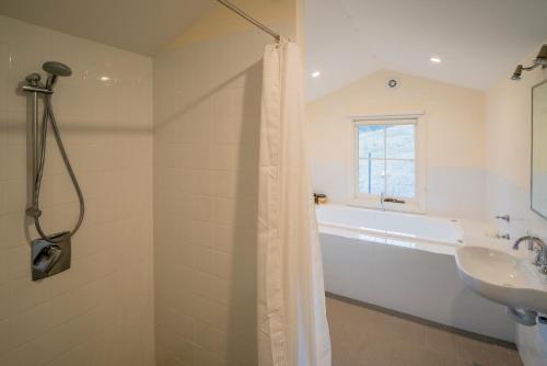 a bathroom with a shower curtain and a sink at St Bernards Presbytery- Hartley Historic Site in Hartley