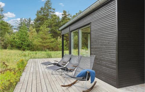 a group of chairs sitting on a deck at Three-Bedroom Holiday Home In Fjerritslev in Slettestrand