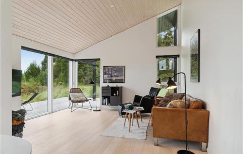 a living room with a couch and chairs and windows at Three-Bedroom Holiday Home In Fjerritslev in Slettestrand