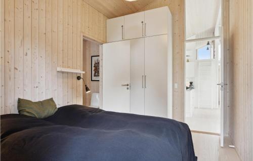 a bedroom with a bed and a white cabinet at Three-Bedroom Holiday Home In Fjerritslev in Slettestrand