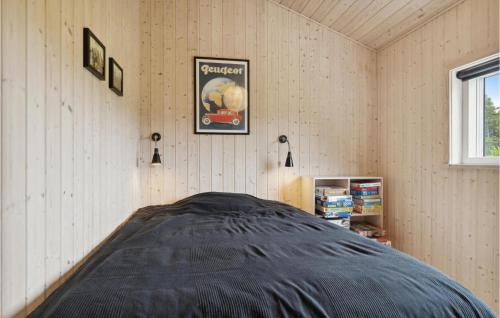 a bedroom with a bed in the corner of a room at Three-Bedroom Holiday Home In Fjerritslev in Slettestrand