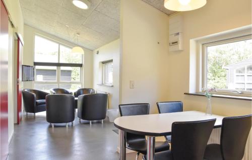 a waiting room with a table and chairs at Holiday Home Halvejen Hytte Spjald in Spjald